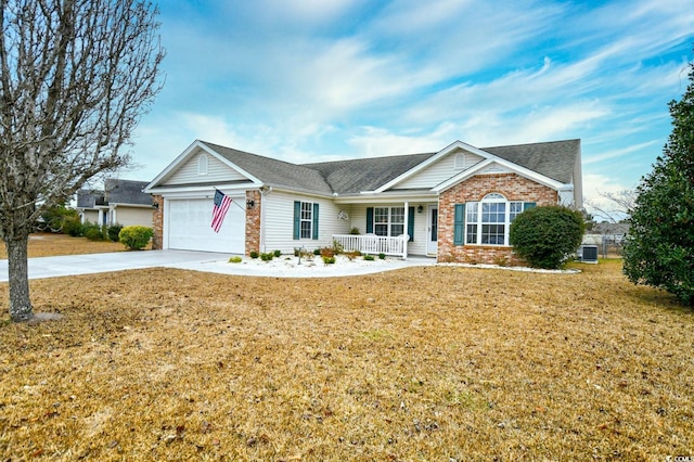 ranch-style home with cooling unit, a garage, a front lawn, and covered porch