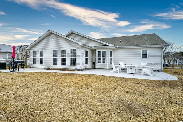 rear view of house featuring a lawn and a patio area