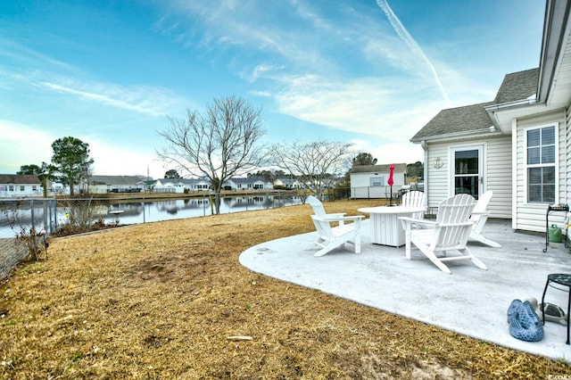 view of yard featuring a water view and a patio