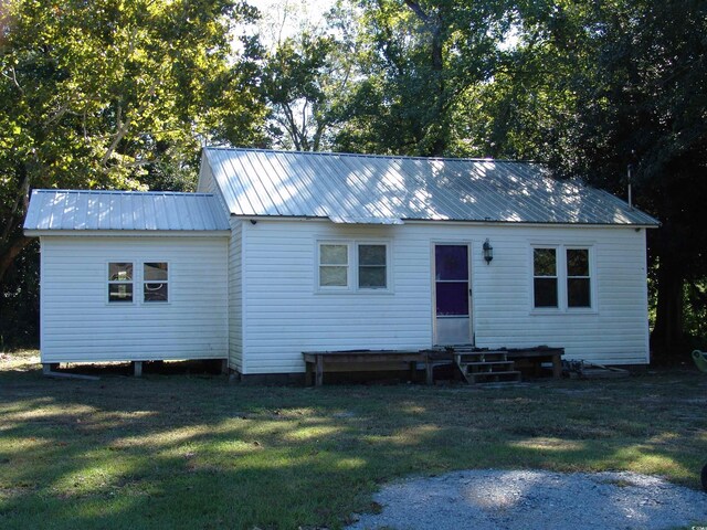 back of property featuring a yard