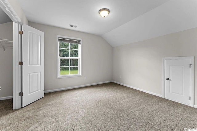 additional living space featuring carpet flooring and lofted ceiling