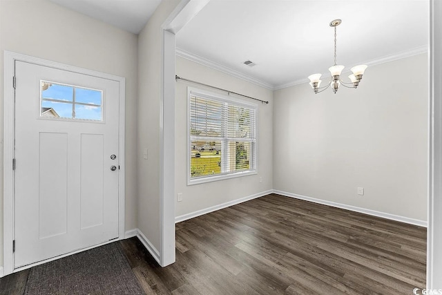 entryway featuring ornamental molding, dark wood-type flooring, and an inviting chandelier