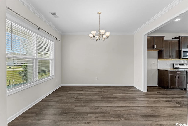 unfurnished dining area featuring a wealth of natural light, a chandelier, and ornamental molding