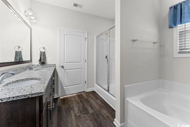 bathroom with vanity, separate shower and tub, and wood-type flooring