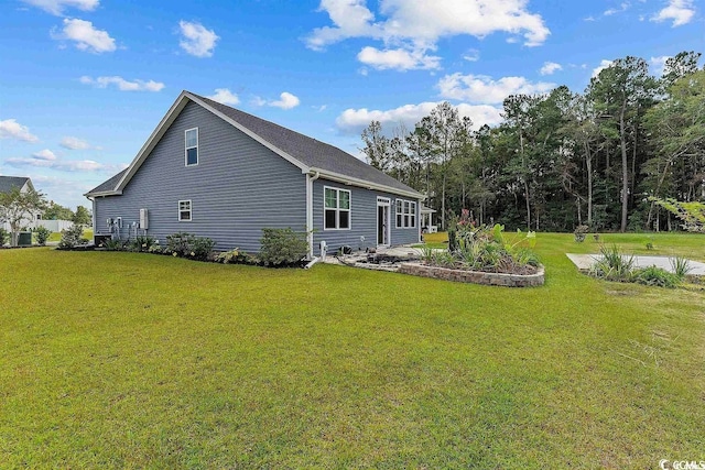 rear view of house featuring a lawn