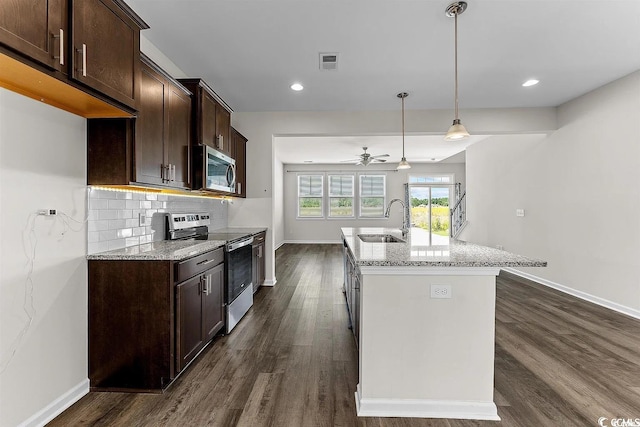 kitchen featuring sink, ceiling fan, light stone counters, and stainless steel appliances