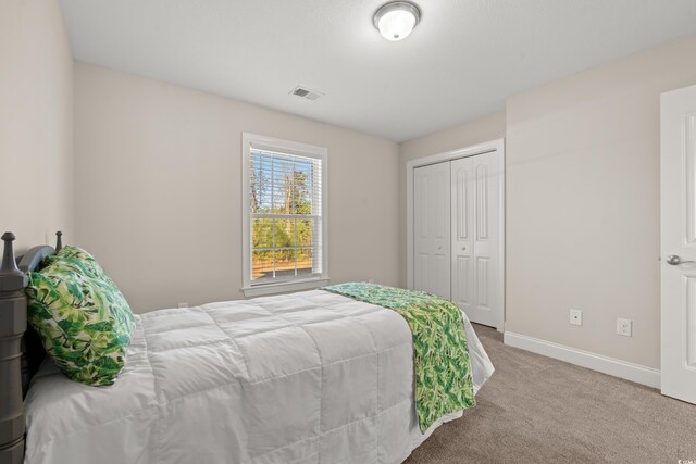 carpeted bedroom featuring a closet