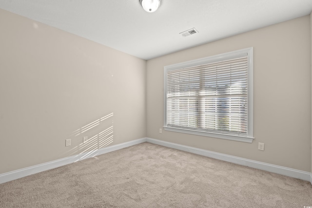 unfurnished room with light carpet