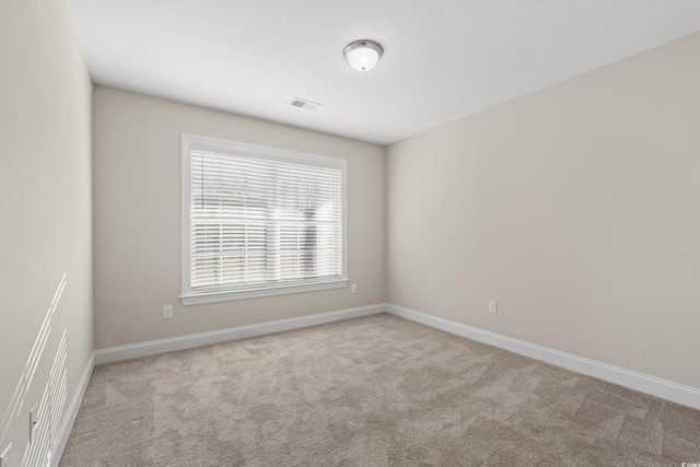 empty room featuring light carpet