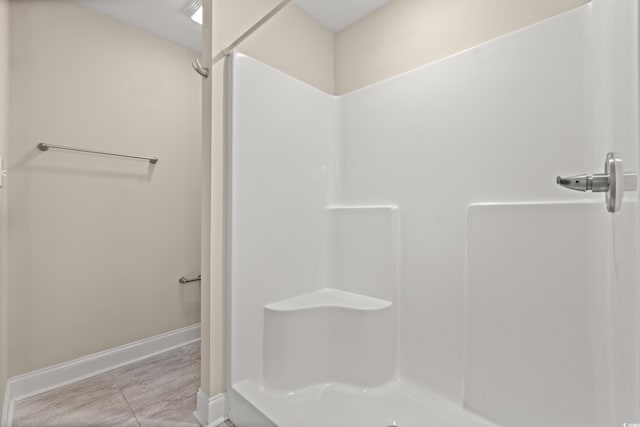 bathroom with tile patterned floors and walk in shower