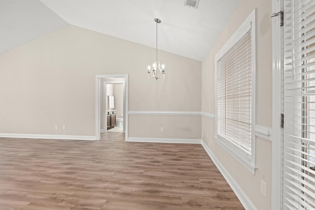 unfurnished dining area with a chandelier, lofted ceiling, and wood-type flooring