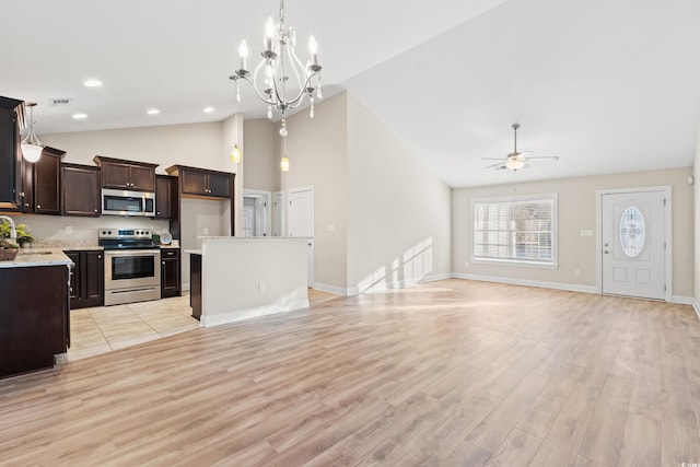 kitchen with ceiling fan with notable chandelier, sink, hanging light fixtures, light hardwood / wood-style flooring, and stainless steel appliances