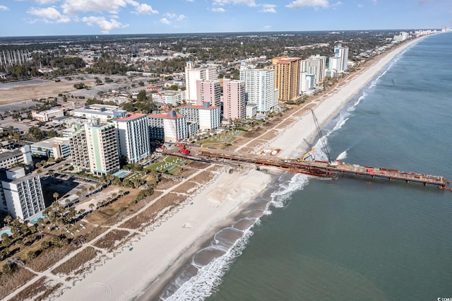 drone / aerial view with a water view and a beach view