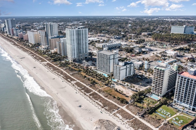 bird's eye view featuring a water view and a beach view