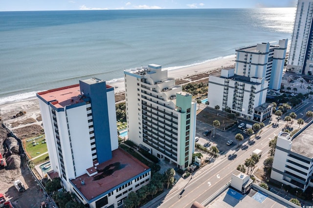 aerial view with a water view and a beach view