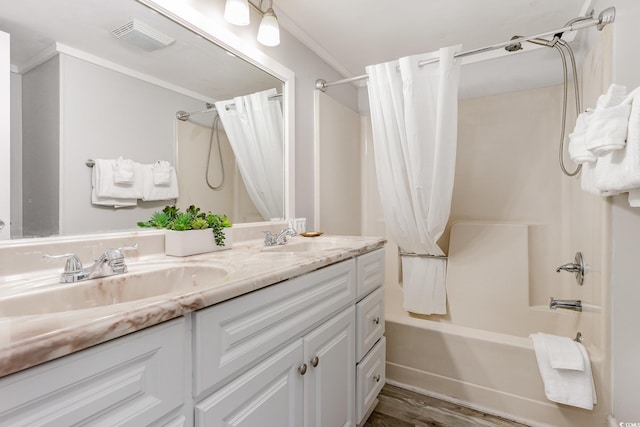 bathroom with shower / bath combination with curtain, vanity, hardwood / wood-style flooring, and crown molding