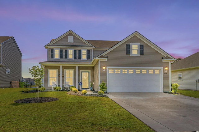 view of front of property featuring a garage, a lawn, and covered porch