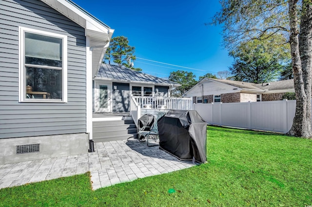 view of yard featuring a wooden deck and a patio area