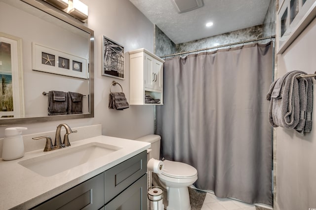 bathroom with vanity, tile patterned flooring, toilet, a textured ceiling, and walk in shower