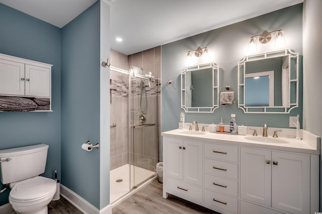 bathroom with hardwood / wood-style flooring, toilet, vanity, and walk in shower