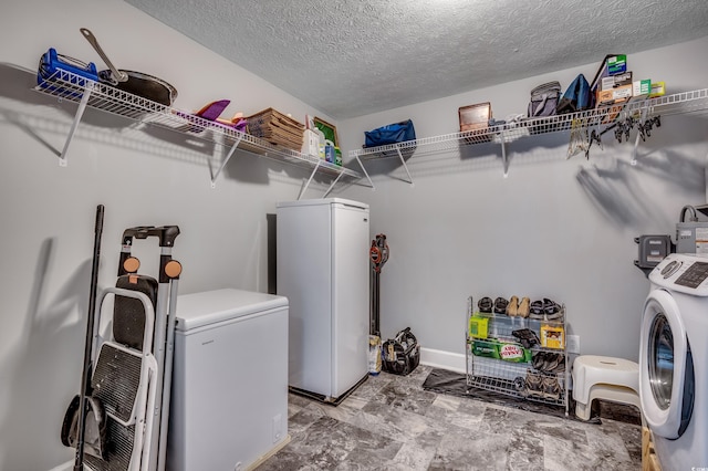 laundry room featuring washer and dryer and a textured ceiling