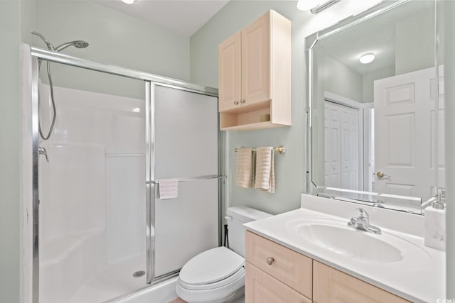 bathroom featuring vanity, toilet, and walk in shower