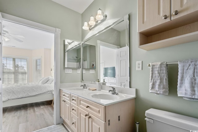 bathroom featuring vanity, ceiling fan, hardwood / wood-style flooring, and toilet