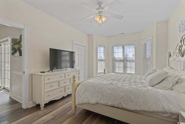 bedroom with dark wood-type flooring and ceiling fan