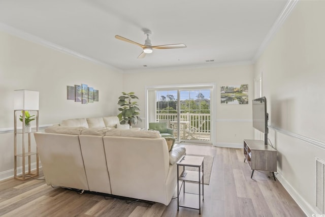 living room with crown molding, ceiling fan, and light hardwood / wood-style flooring