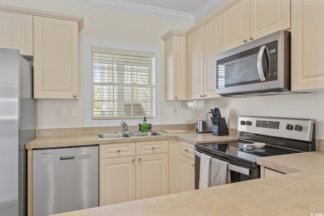 kitchen featuring crown molding, stainless steel appliances, and sink