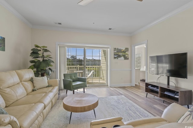 living room featuring crown molding and light hardwood / wood-style flooring