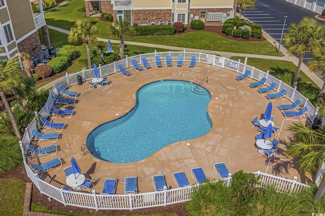 view of pool with a yard and a patio area