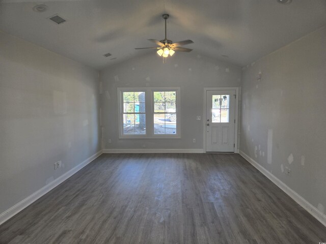 unfurnished living room with dark hardwood / wood-style flooring, vaulted ceiling, and ceiling fan