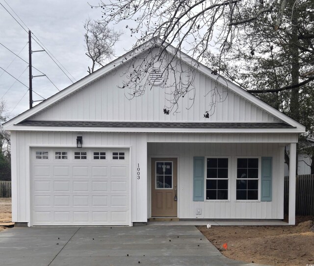 view of front of house with a garage and an outdoor structure