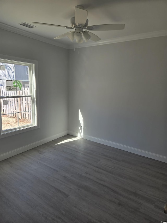 empty room featuring ceiling fan, dark hardwood / wood-style flooring, and crown molding