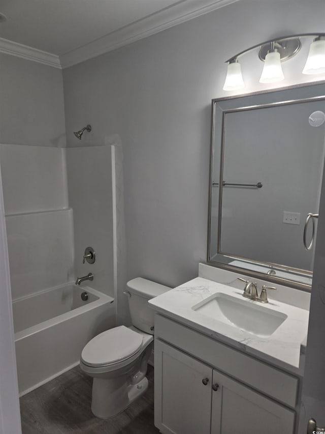 full bathroom with toilet, vanity,  shower combination, hardwood / wood-style flooring, and ornamental molding