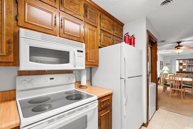 kitchen with ceiling fan, light tile patterned floors, and white appliances