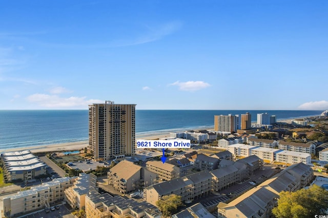 birds eye view of property featuring a view of the beach and a water view