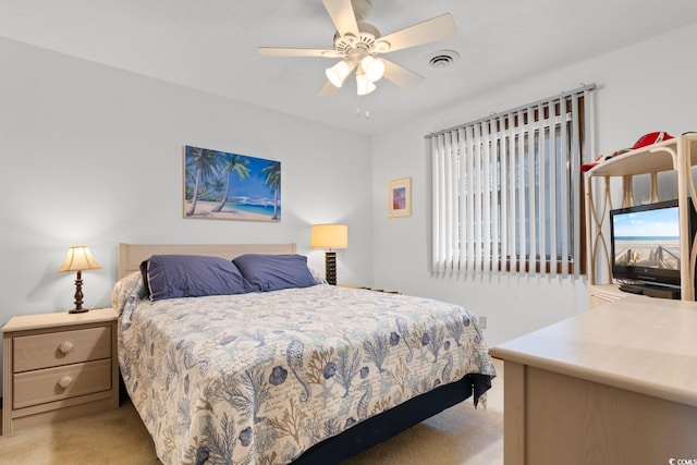 bedroom featuring light carpet and ceiling fan