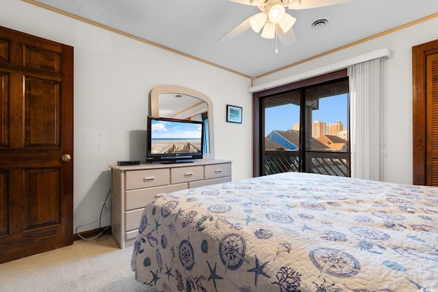 carpeted bedroom with access to exterior, ceiling fan, and ornamental molding