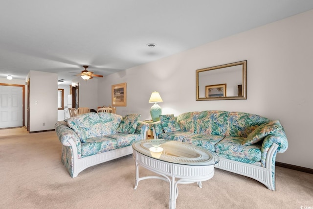 carpeted living room with ceiling fan