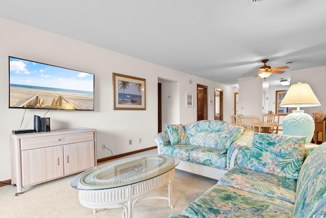 carpeted living room featuring ceiling fan