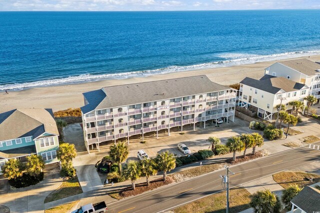 bird's eye view with a water view and a beach view