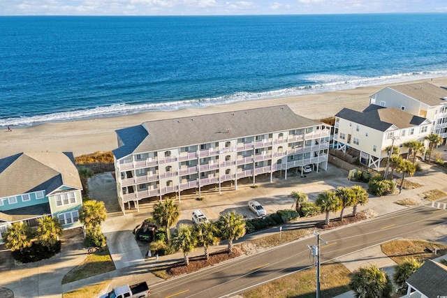 bird's eye view with a water view and a beach view