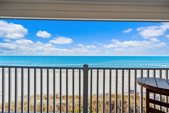 balcony with a beach view and a water view