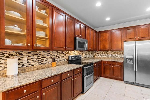 kitchen featuring decorative backsplash, light stone counters, crown molding, and appliances with stainless steel finishes