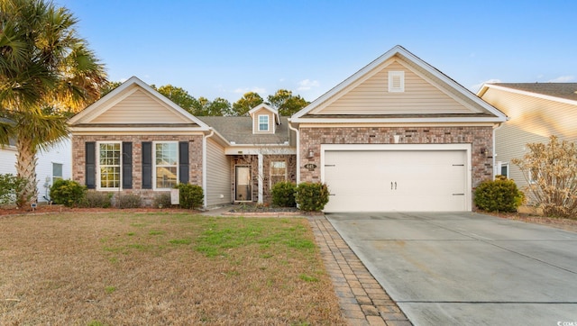 view of front of house with a front lawn and a garage