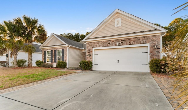 view of front of property featuring a garage and a front lawn