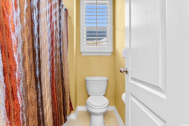 bathroom with tile patterned floors and toilet