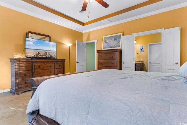 bedroom featuring ensuite bath, ceiling fan, light carpet, and ornamental molding